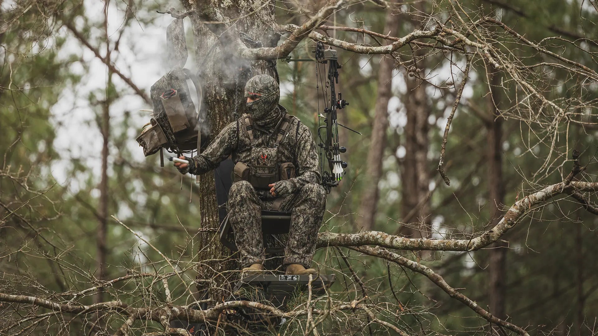 male hunter sitting in tree stand