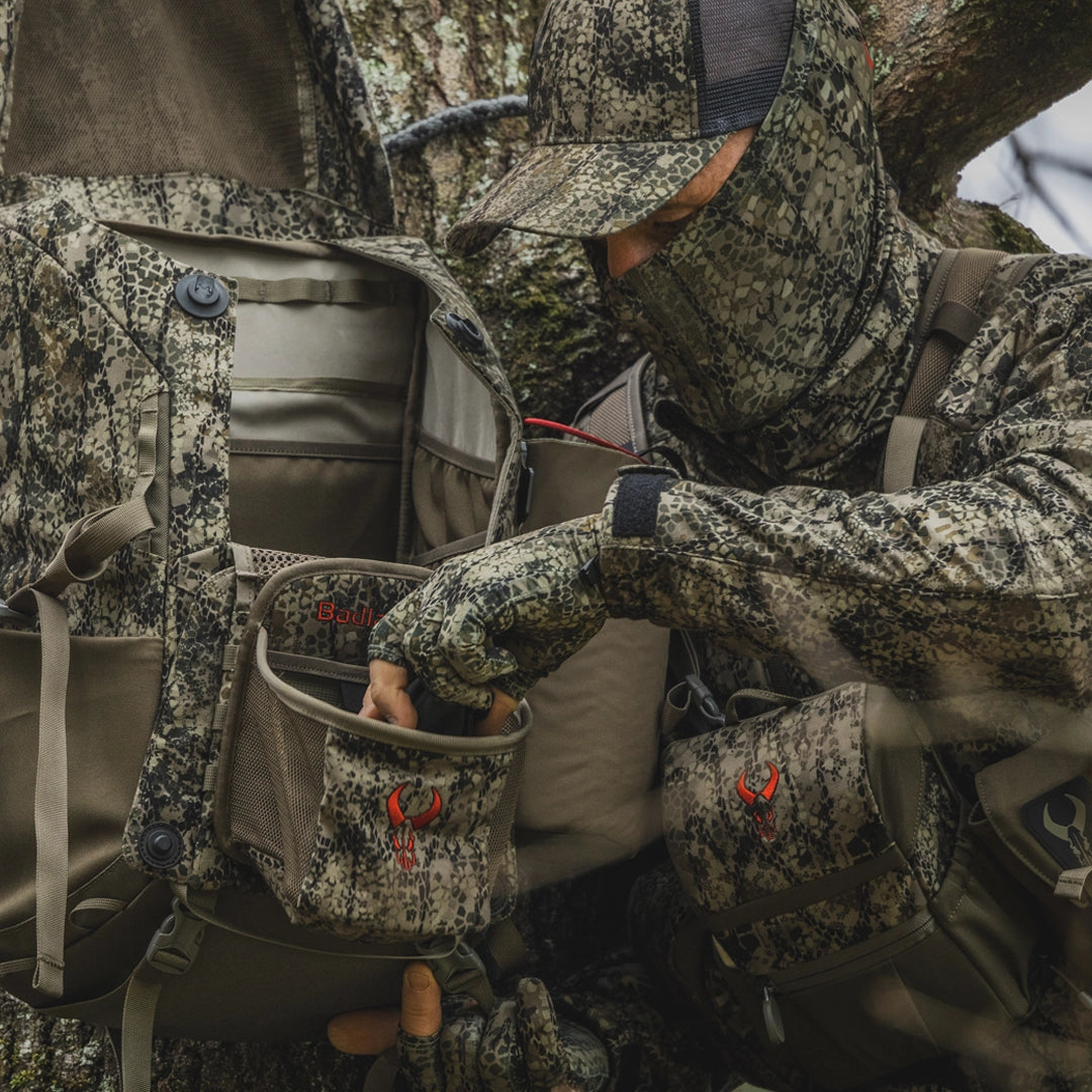 Hunter with pack and binocular harness in rise pro